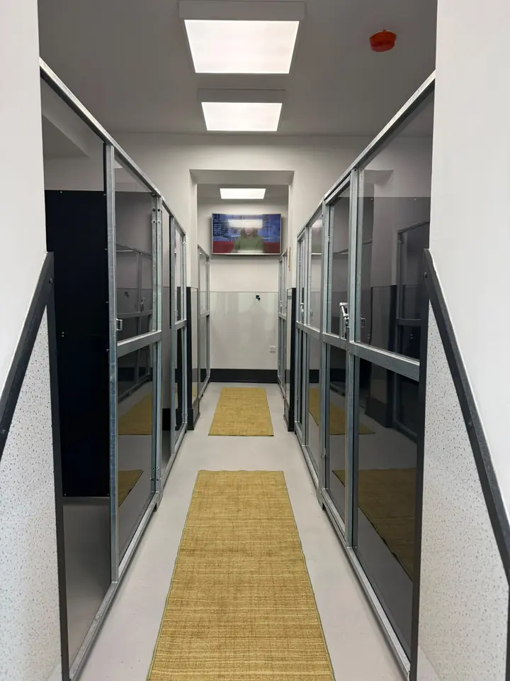 The bedroom corridor, with a glass fronted room on each side